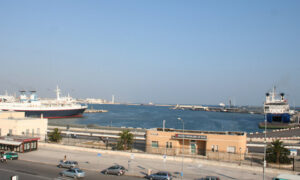 Adriatic seaport, showing the port with docked ships and parked cars on the road