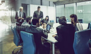 Board meeting setting with people around a table