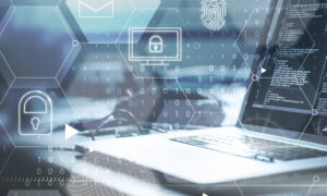 Fingerprint, security icons, binary numbers over an open laptop , with hexagon shapes in the background