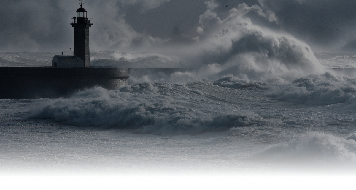 Stormy waves crashing against a lighthouse