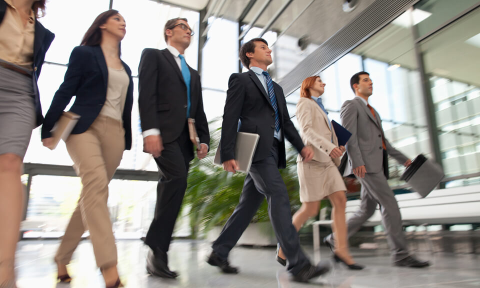 business people walking in a foyer