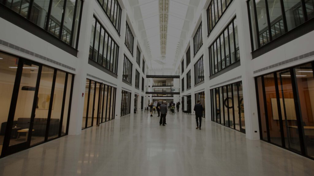 Bellworks Chicagoland atrium showing people walking and standing talking