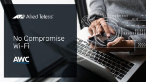 Laptop & mobile phone being used by a male person near a window